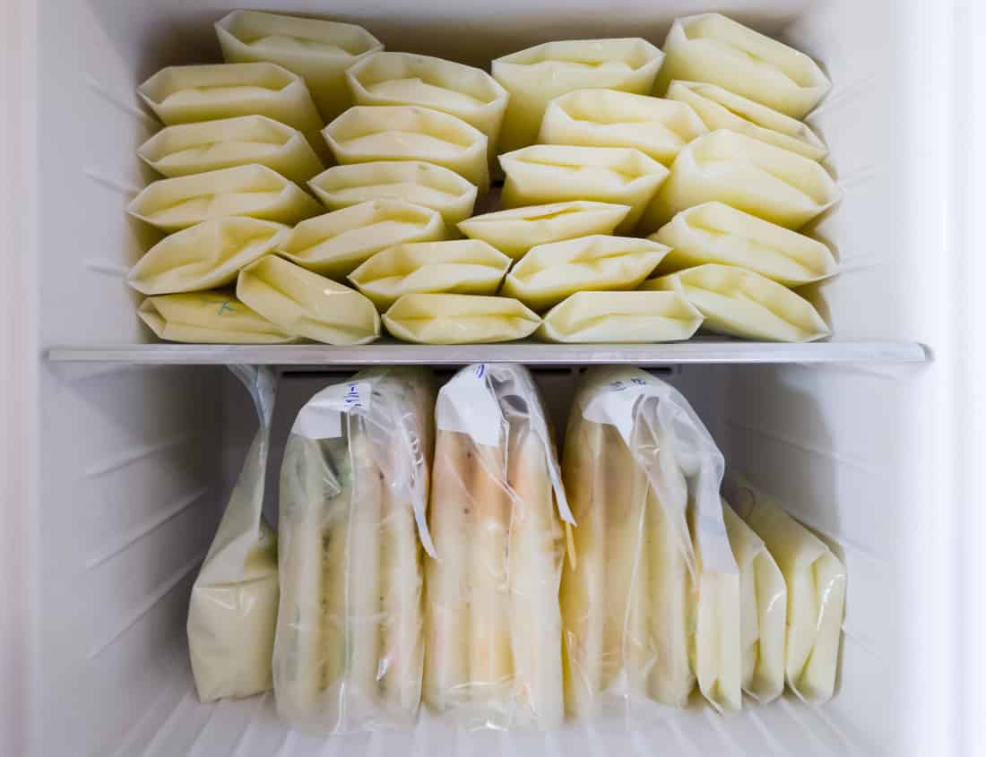 many bags of frozen breastmilk stockpile in freezer